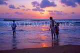 SRI LANKA, south coast, Gintota, sunset, people paddling on beach, SLK1688JPL