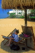 SRI LANKA, south coast, Mount Lavinia Hotel beach, boy having a drink under sunshade, SLK1768JPL
