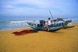 SRI LANKA, south coast, Mount Lavinia beach, boy seated on fishing catamaran, SLK1779JPL