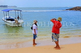SRI LANKA, south coast, Unawatuna, beach, holidaymakers taking a photo, SLK4702JPL