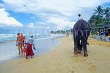 SRI LANKA, west coast, beach with tourists and boy on elephant ride, SLK2021JPL