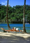ST LUCIA, Marigot Bay, Marigot Beach resort, couple on sunbeds, STL639JPL