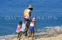 ST LUCIA, Reduit Beach, St Lucian family walking along beach, STL690JPL