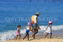 ST LUCIA, Reduit Beach, St Lucian family walking along beach, STL778JPL