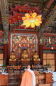 South Korea, SEOUL, Bongeunsa Temple, Daewoongjeon hall, wooden Buddhas and monk, SK849JPL