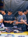 THAILAND, Bangkok, Chatuchak Weekend Market, shoppers at stall selling wallets, THA1791JPL