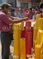 THAILAND, Bangkok, Chinese New Year, lighting candles for good luck at a shrine, THA2099JPL
