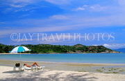 THAILAND, Ko Samui Island, coast, and sunbather with umbrella on beach, THA1963JPL