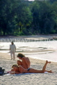 THAILAND, Ko Samui Island, couple of sunbathers on beach, THA1389JPL