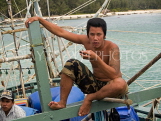 THAILAND, Koh Phangan Island, Chalok Lum fishing village, fisherman on boat, THA2028JPL