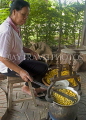 THAILAND, Surin, Queen Sirikit Sericulture Center, worker drawing silk from silkworm cocoons, THA2067JPL