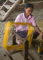 THAILAND, Surin, Queen Sirikit Sericulture Center, worker spinning silk thread, THA2068JPL
