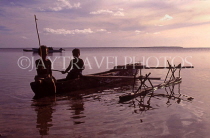 TONGA, Atata Island, two Tongan children fishing from small catamaran, dusk, TON2243JPLA