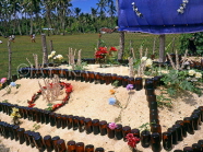 TONGA, Nukualofa, cemetery, typical burial mound decorated with beer bottles, TON2417JPL