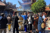 Taiwan, TAIPEI, Lungshan Temple, worshippers by incense burner censer, TAW662JPL