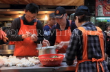 Taiwan, TAIPEI, Raohe Street Night Market, food stall, vendors preparing dumplings, TAW972JPL