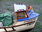 UK, Devon, BRIXHAM, harbourfront, man cleaning boat, UK6037JPL