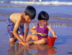 UK, Devon, PAIGNTON, two children on beach, playing with bucket and spade, DEV366JPL