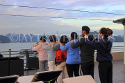 VIETNAM, Halong Bay, dawn, cruise boat, tourists practicing Tai Chi on board, VT1836JPL