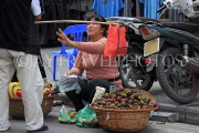 Vietnam, HANOI, Old Quarter, Street Vendor, with Mangosteen fruit in basket, VT1626JPL