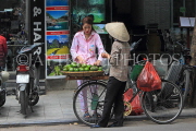 Vietnam, HANOI, Old Quarter, Street Vendor, with customer, selling fruit, VT1500JPL