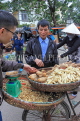 Vietnam, HANOI, outdoor market, street vendor selling yams and nuts, VT1095JPL