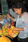BAHRAIN, Manama, Central Market, shopper buying Mangoes, BHR1292JPL