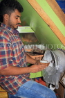BAHRAIN, Manama, Central Market area, Asian small shops, man scraping coconut, BHR1324JPL