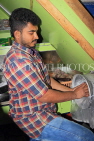 BAHRAIN, Manama, Central Market area, Asian small shops, man scraping coconut, BHR1325JPL