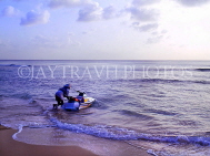 BARBADOS, West Coast, water scooter going out to sea, BAR1157JPL