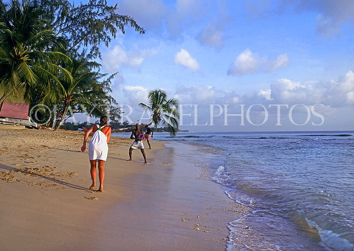BARBADOS, West Coast beach, tourist playing beach ball, BAR457JPL