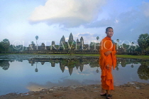 CAMBODIA, Angkor Wat, monk standing in front of temple site, CAM64JPL