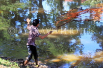 CAMBODIA, Siem Reap, town centre, Siem Reap River, fisherman casting net, CAM2303JPL