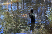 CAMBODIA, Siem Reap, town centre, Siem Reap River, fisherman with net, CAM2302JPL