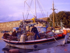 Greek Islands, KOS, Kos Town, harbourfront, castle walls and fishing boat, GIS1150JPL