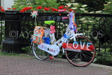 HOLLAND, Edam, decorated bike by a canalside bridge, HOL814JPL