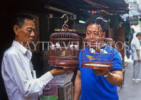HONG KONG, Kowloon, Mong Kok, Yuen Po Street Bird Garden, two buyer with singing birds, HK291JPL