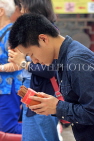 HONG KONG, Kowloon, Wong Tai Sin Temple, worshipper shaking Fortune Sticks, HK1150JPL