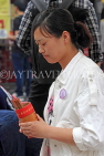 HONG KONG, Kowloon, Wong Tai Sin Temple, worshipper shaking Fortune Sticks, HK1152JPL
