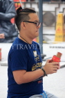 HONG KONG, Kowloon, Wong Tai Sin Temple, worshipper shaking Fortune Sticks, HK1160JPL