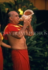 Hawaiian Islands, OAHU, man blowing conch shell, in ceremony, HAW105JPL