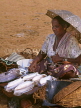 SRI LANKA, Negombo, fish market scene, fishwife selling squid, SLK277JPL