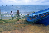 SRI LANKA, Negombo, fishermen sorting nets on beach, SLK1652JPL
