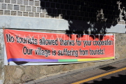 South Korea, SEOUL, Bukchon Hanok Village, sign hung against too many tourists, SK988JPL
