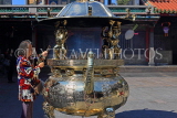 Taiwan, TAIPEI, Lungshan Temple, worshipper by incense burner censer, TAW658JPL