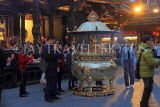 Taiwan, TAIPEI, Lungshan Temple, worshippers by incense burner censer, night view, TAW629JPL