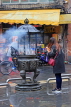 Taiwan, TAIPEI, Xia Hai City God Temple, worshipper at incense burner censer, TAW936JPL
